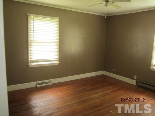 595 Providence Road Roxboro, NC 27573 - Photo 6 of 14 an empty room with wooden floor and windows