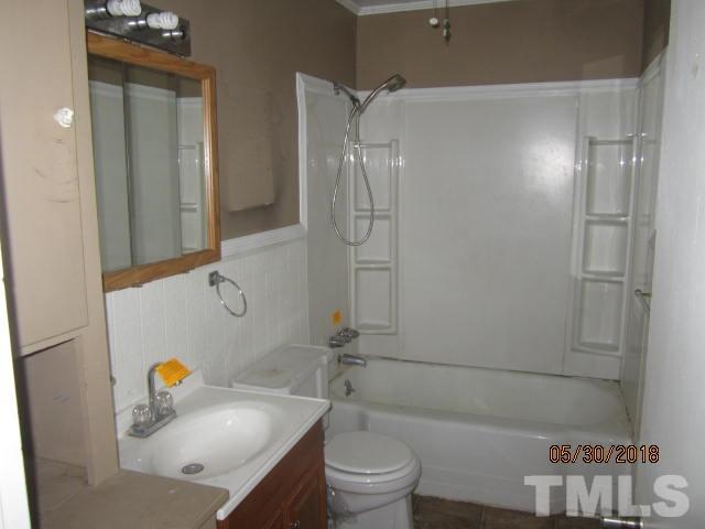 595 Providence Road Roxboro, NC 27573 - Photo 7 of 14 a bathroom with a sink a toilet and shower