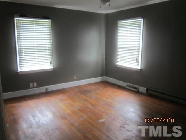 595 Providence Road Roxboro, NC 27573 - Photo 8 of 14 a view of an empty room with wooden floor and a window
