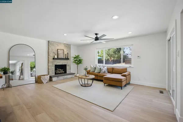 a living room with furniture and a fireplace