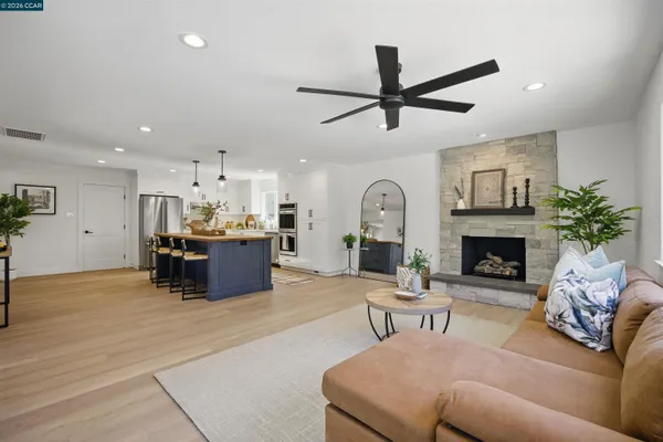 a kitchen with stainless steel appliances a dining table and chairs