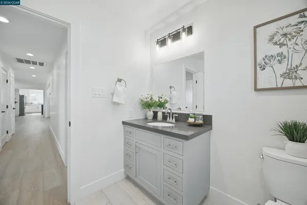 a bathroom with a granite countertop sink a mirror and a shower