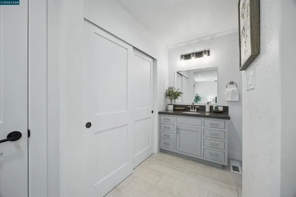 a bathroom with a toilet a sink and mirror