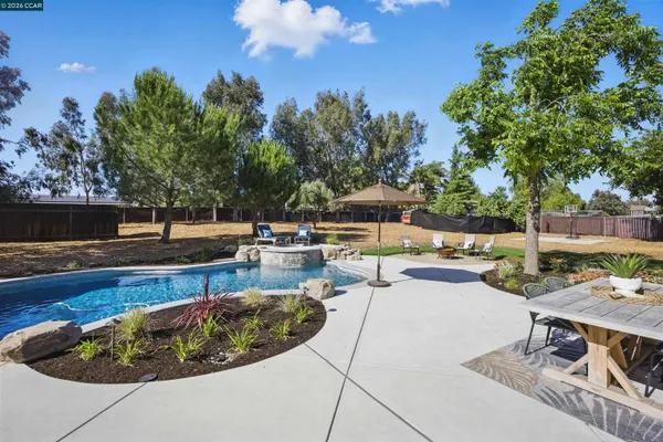 a view of a backyard with sitting area