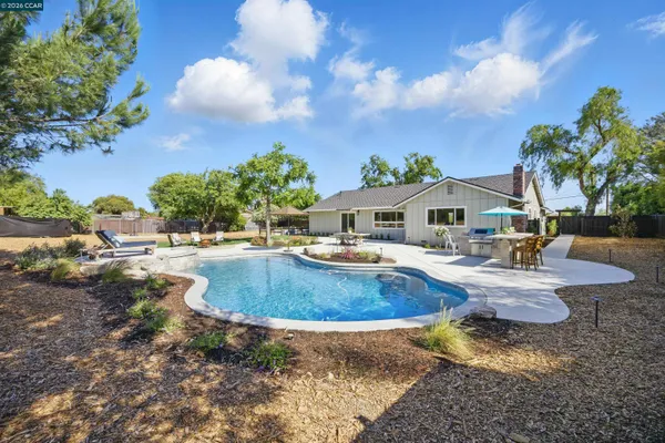 a view of a swimming pool with outdoor seating