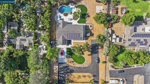 an aerial view of a house with yard
