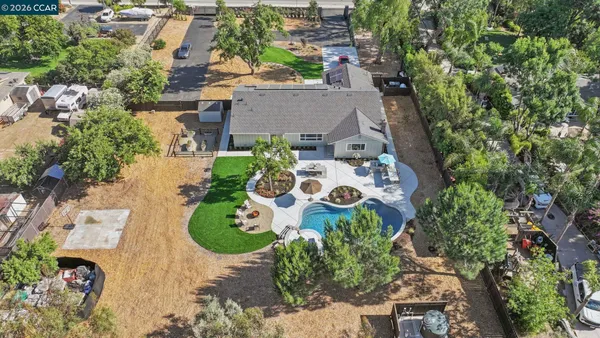 an aerial view of house with yard swimming pool and outdoor seating
