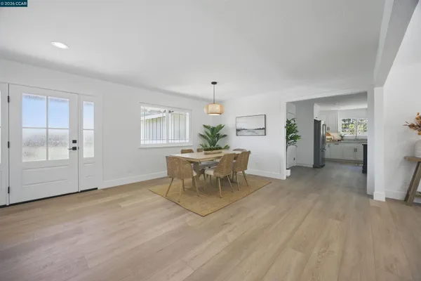a view of a dining room with furniture window and wooden floor
