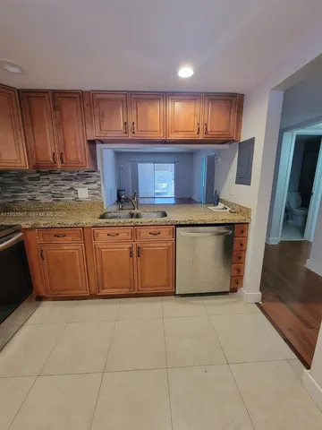 a kitchen with a stove window and cabinets