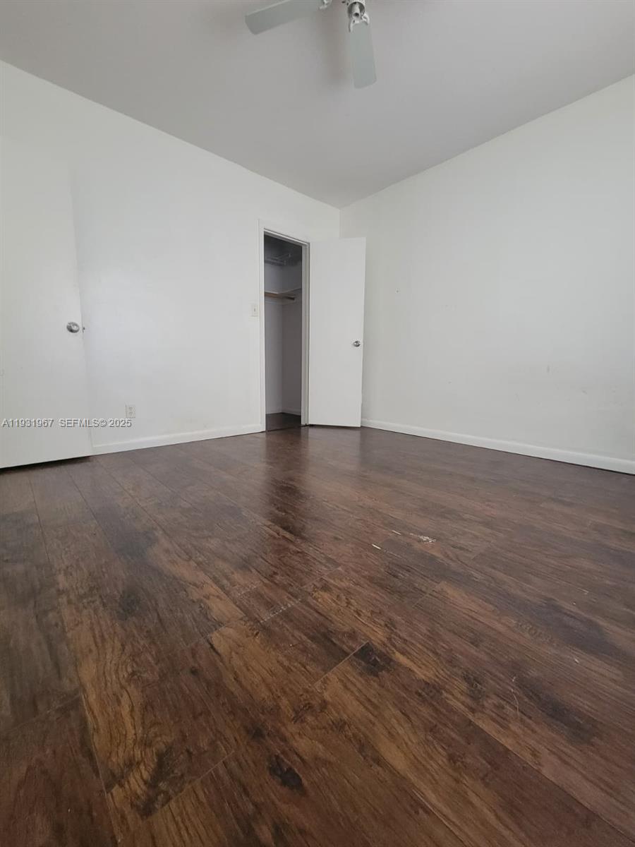 4321 Northwest 9th Avenue, Unit 102 Deerfield Beach, FL 33064 - Photo 17 of 34 a view of an empty room with wooden floor