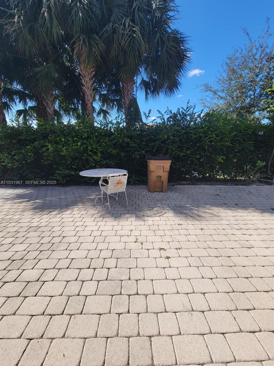 4321 Northwest 9th Avenue, Unit 102 Deerfield Beach, FL 33064 - Photo 31 of 34 a view of a yard and patio
