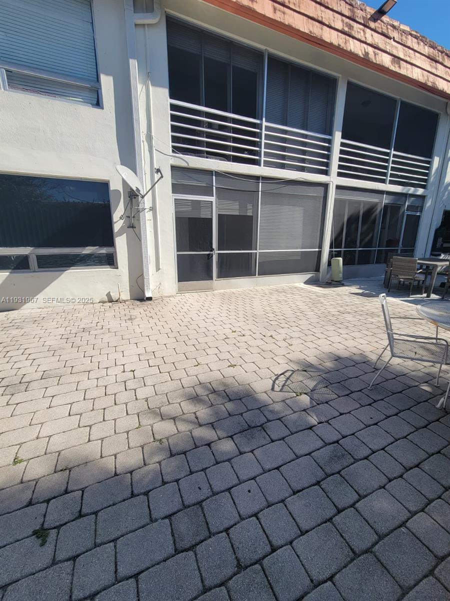 4321 Northwest 9th Avenue, Unit 102 Deerfield Beach, FL 33064 - Photo 32 of 34 a front view of a house with a yard