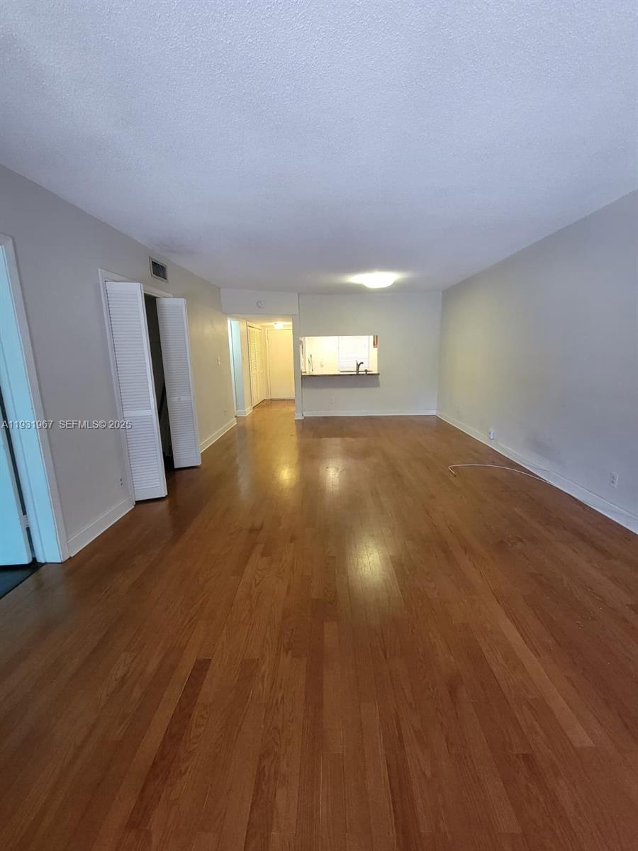4321 Northwest 9th Avenue, Unit 102 Deerfield Beach, FL 33064 - Photo 7 of 34 a view of empty room with wooden floor