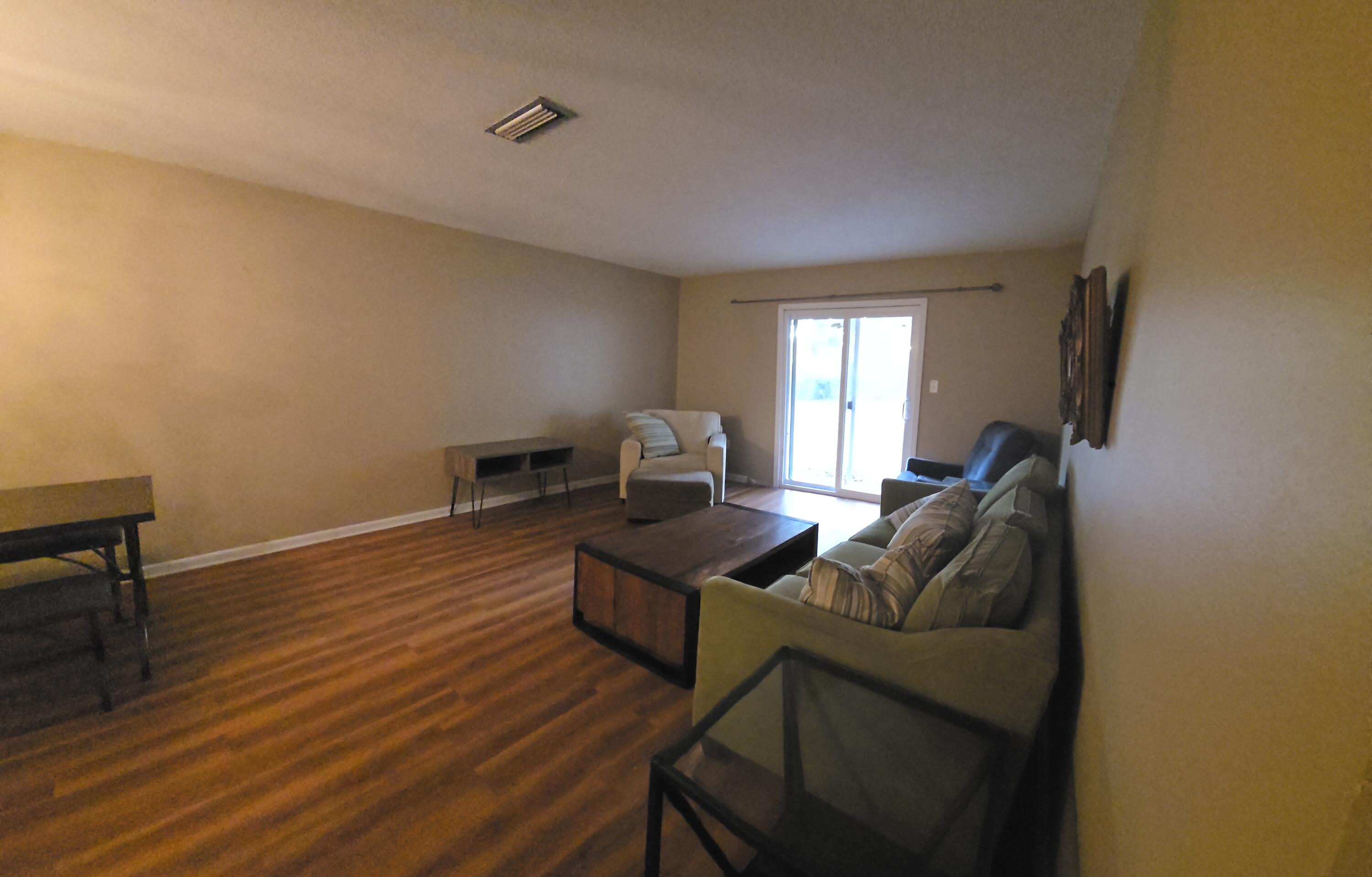 17 7th Street, Unit 2 Shalimar, FL 32579 - Photo 11 of 29 a living room with furniture and a wooden floor