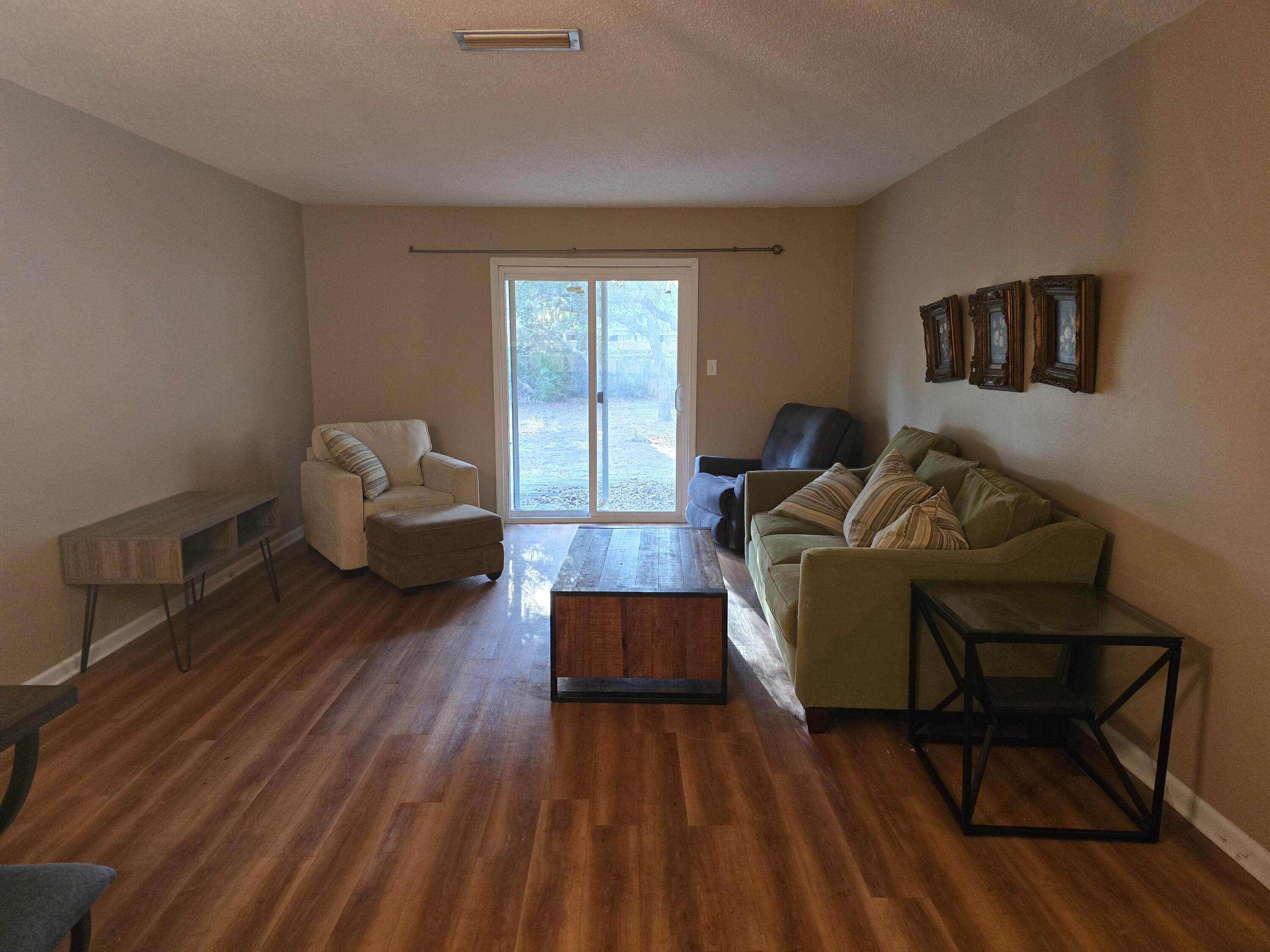 17 7th Street, Unit 2 Shalimar, FL 32579 - Photo 13 of 29 a living room with furniture and a wooden floor