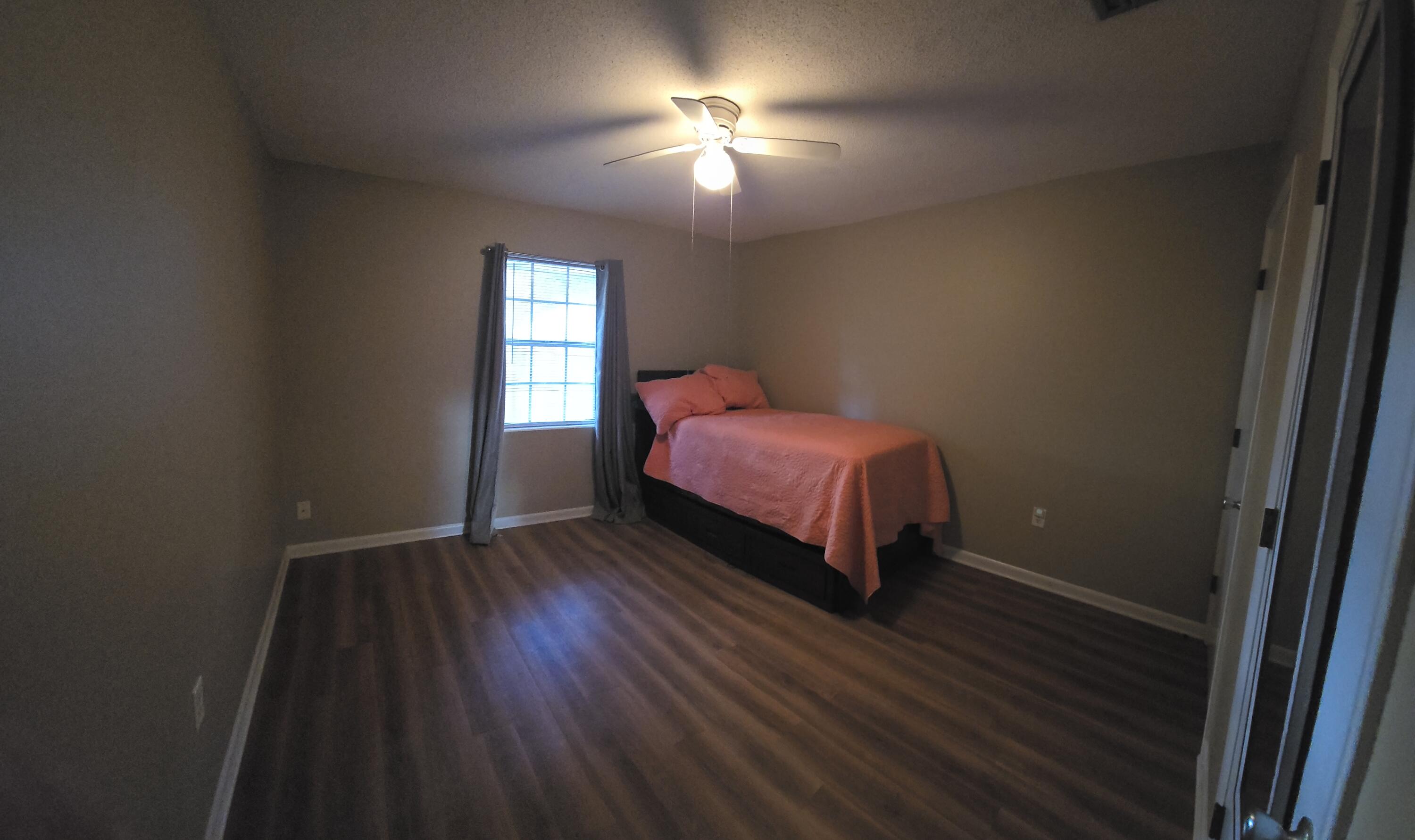 17 7th Street, Unit 2 Shalimar, FL 32579 - Photo 20 of 29 a bedroom with a bed and a window