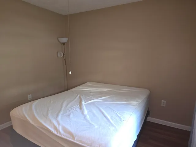 a bedroom with a bed and a night stand