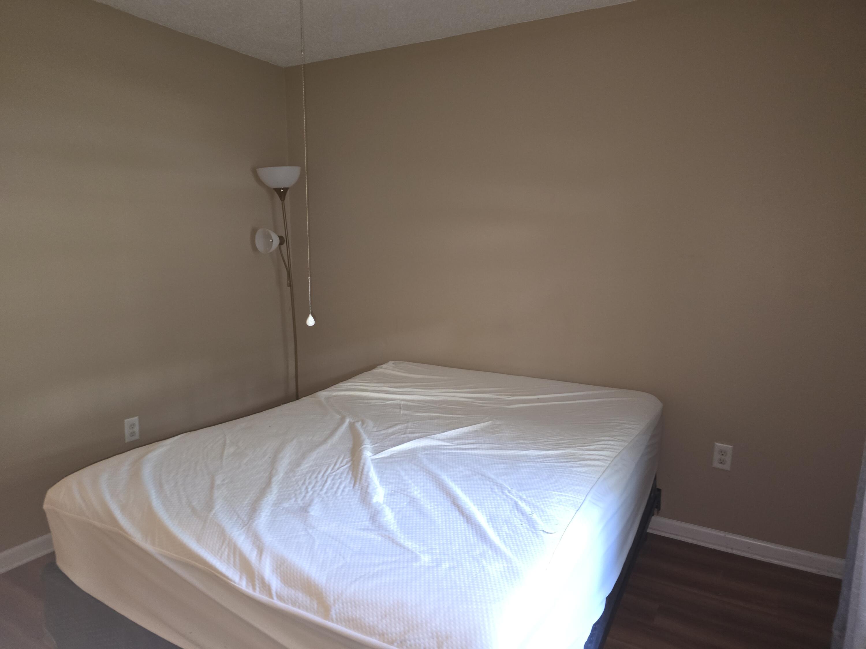 17 7th Street, Unit 2 Shalimar, FL 32579 - Photo 21 of 29 a bedroom with a bed and a night stand