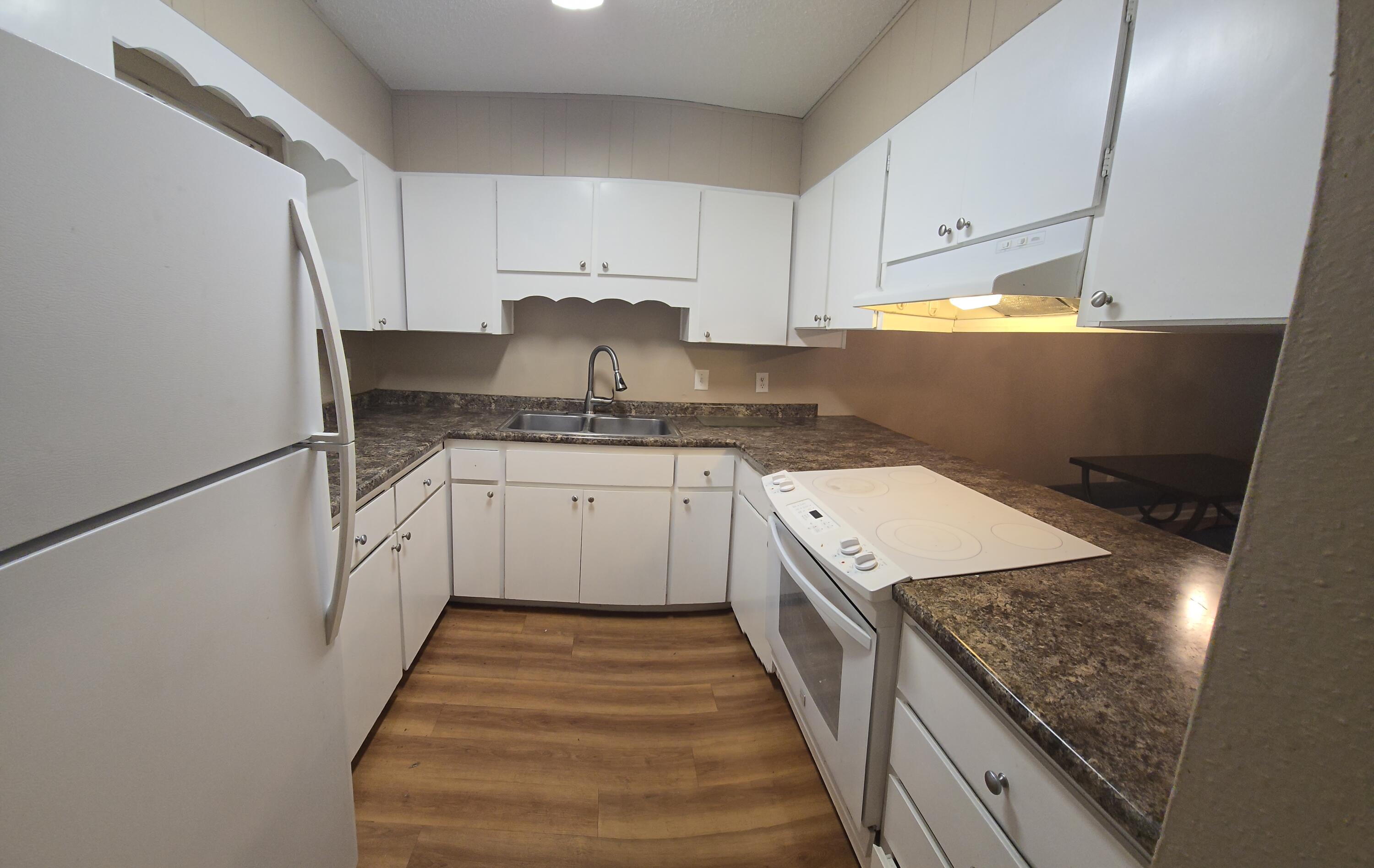 17 7th Street, Unit 2 Shalimar, FL 32579 - Photo 3 of 29 a kitchen with a sink stove and cabinets