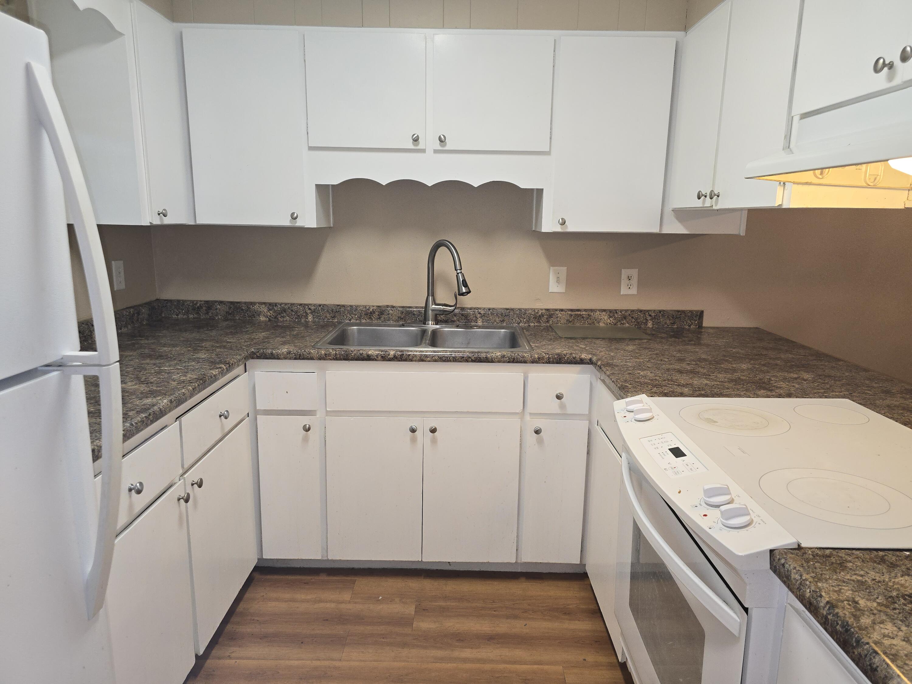 17 7th Street, Unit 2 Shalimar, FL 32579 - Photo 4 of 29 a kitchen with granite countertop a sink and cabinets