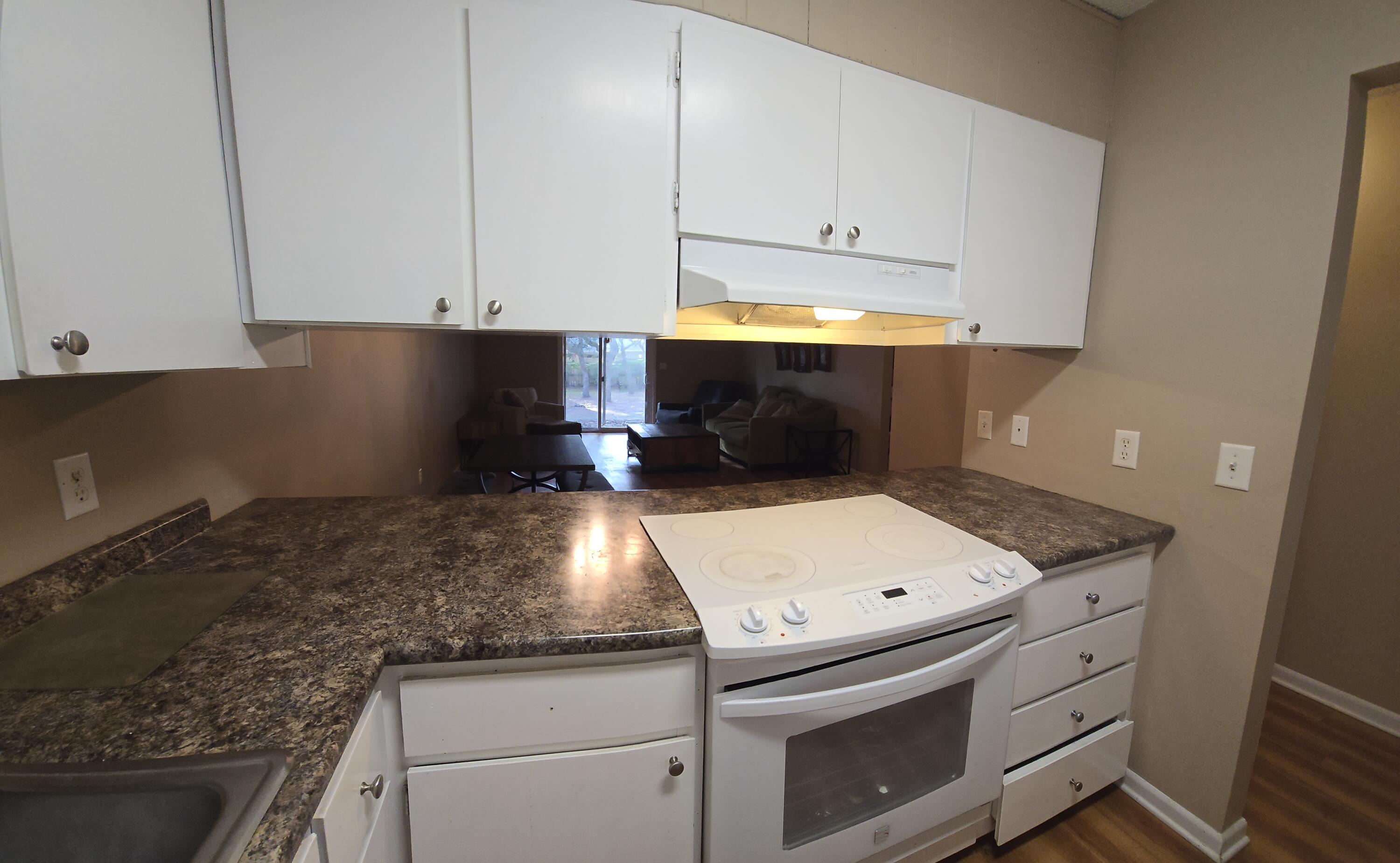 17 7th Street, Unit 2 Shalimar, FL 32579 - Photo 5 of 29 a kitchen with granite countertop white cabinets and white appliances