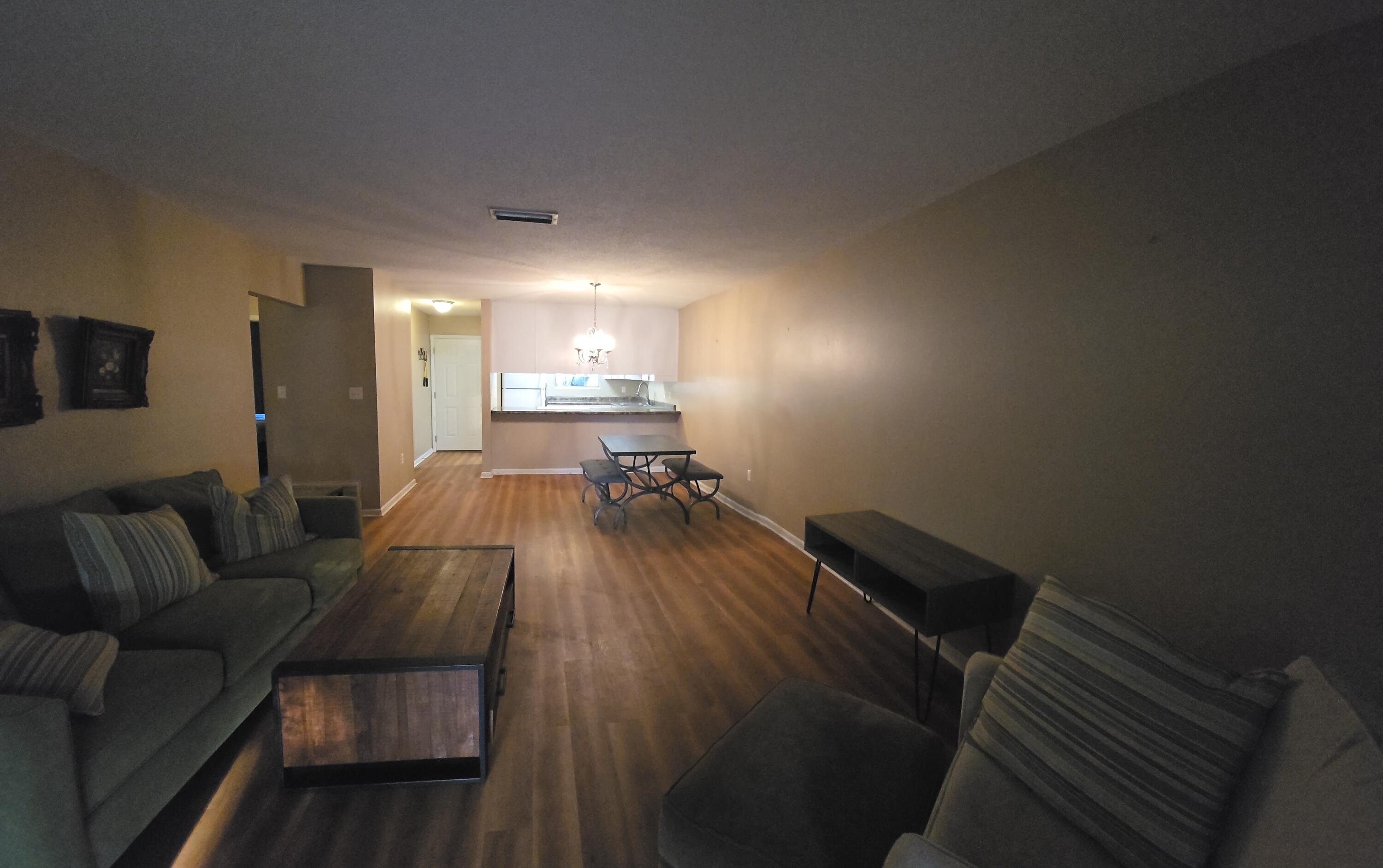 17 7th Street, Unit 2 Shalimar, FL 32579 - Photo 9 of 29 a living room with furniture and a wooden floor