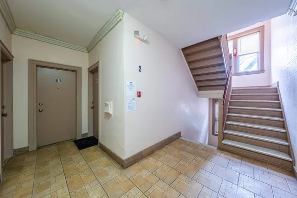 a view of a livingroom with wooden floor and windows