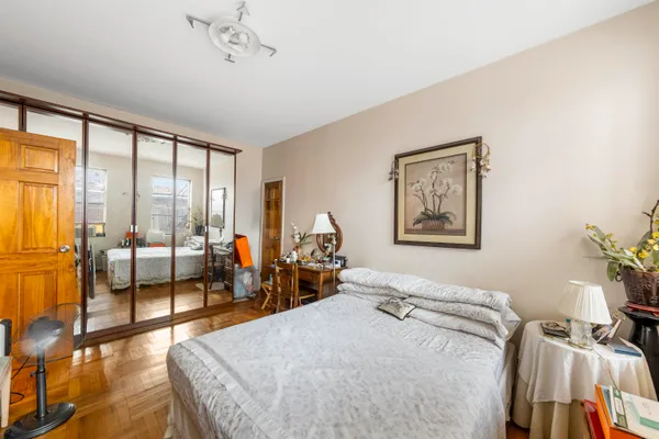 a bedroom with furniture and large window