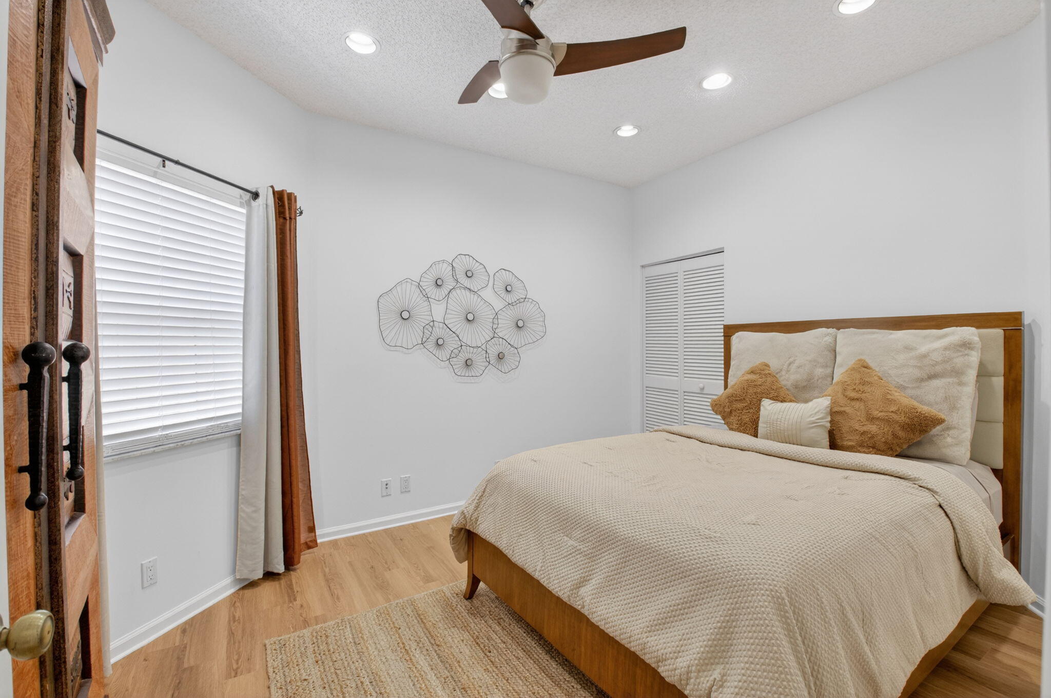 6694 Northwest 26th Way Boca Raton, FL 33496 - Photo 28 of 58 a bedroom with a large bed and a chandelier