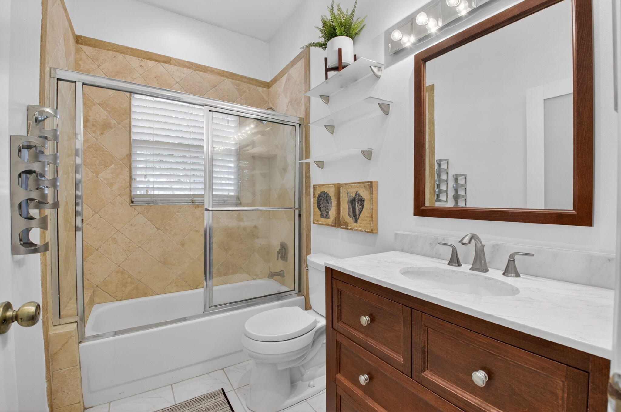 6694 Northwest 26th Way Boca Raton, FL 33496 - Photo 29 of 58 a bathroom with a sink a mirror a toilet and shower
