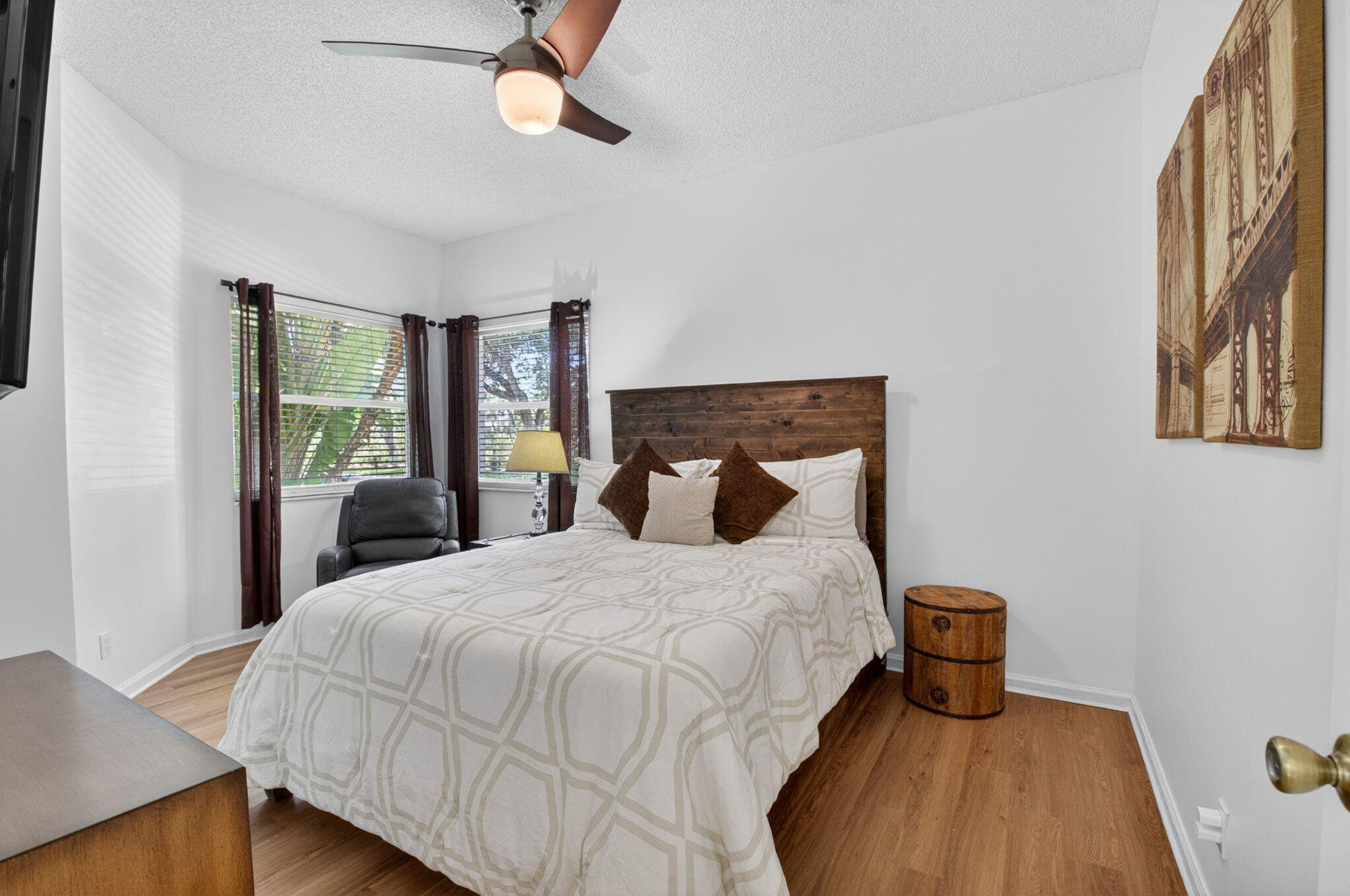 6694 Northwest 26th Way Boca Raton, FL 33496 - Photo 30 of 58 a bedroom with a bed a dresser and a window