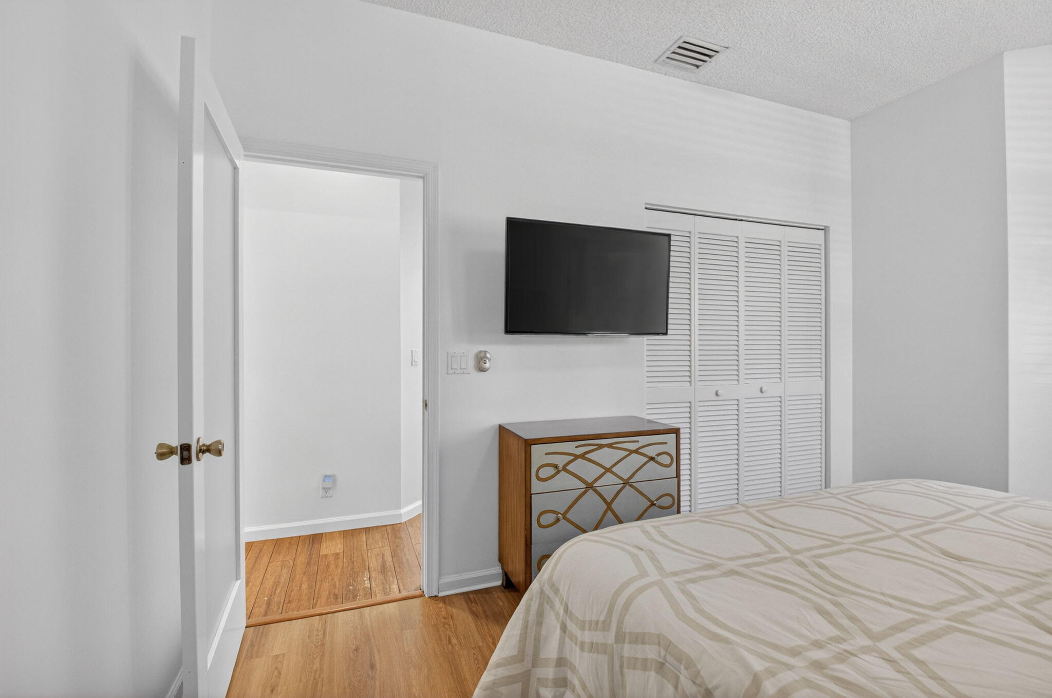 6694 Northwest 26th Way Boca Raton, FL 33496 - Photo 31 of 58 a bedroom with a bed and a flat screen tv