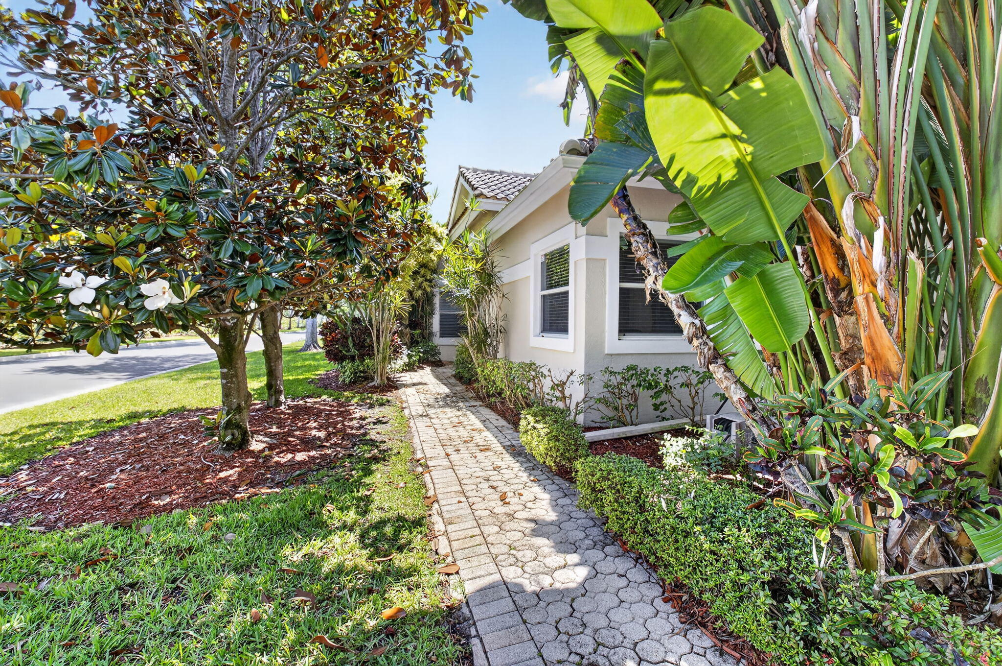 6694 Northwest 26th Way Boca Raton, FL 33496 - Photo 4 of 58 a front view of a house with garden