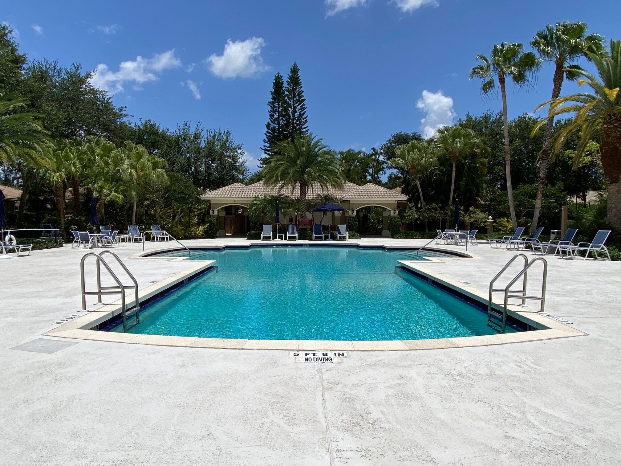 6694 Northwest 26th Way Boca Raton, FL 33496 - Photo 47 of 58 a view of swimming pool with outdoor seating and trees in the background