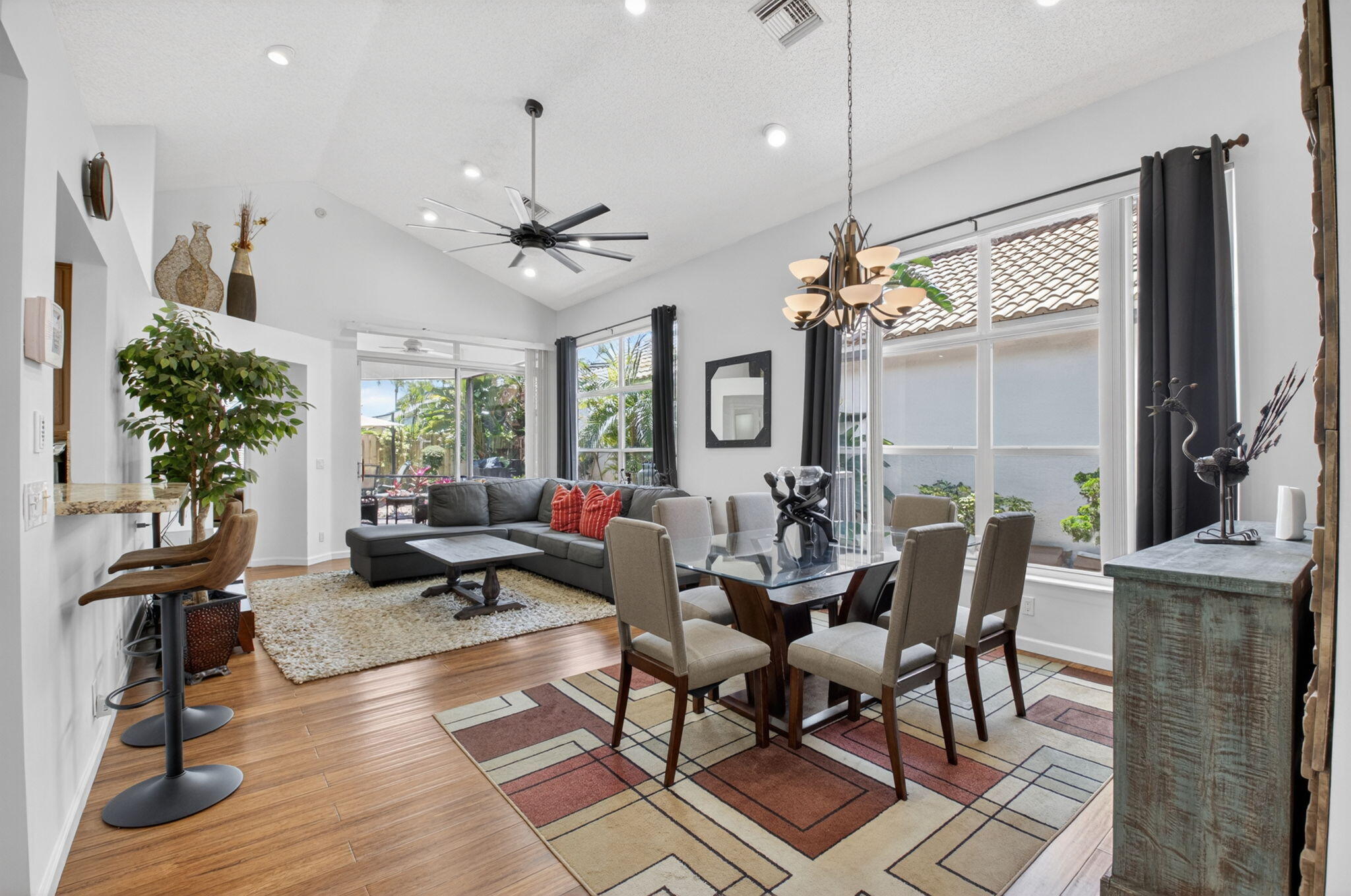 6694 Northwest 26th Way Boca Raton, FL 33496 - Photo 7 of 58 a living room with furniture a large window and a chandelier
