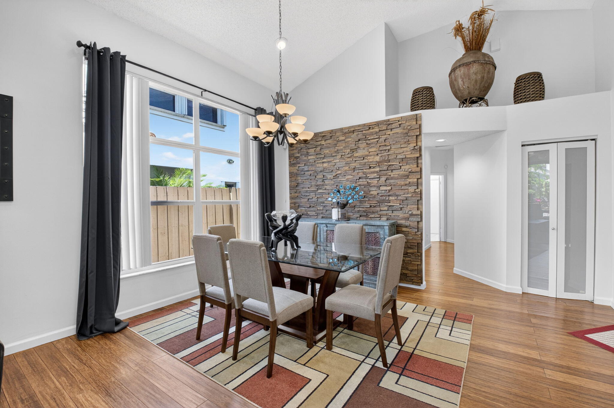 6694 Northwest 26th Way Boca Raton, FL 33496 - Photo 9 of 58 a dining room with furniture wooden floor a chandelier