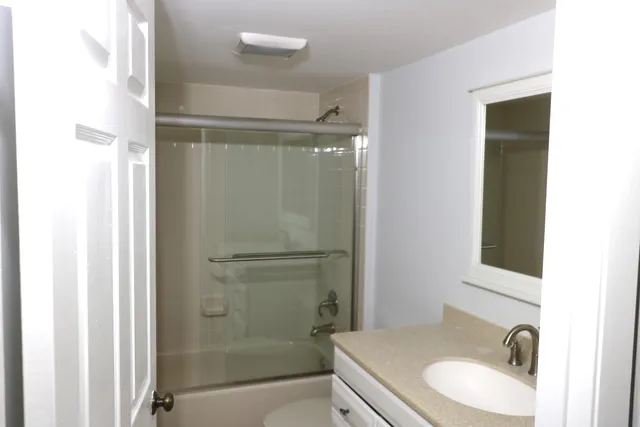 a bathroom with a sink toilet and shower