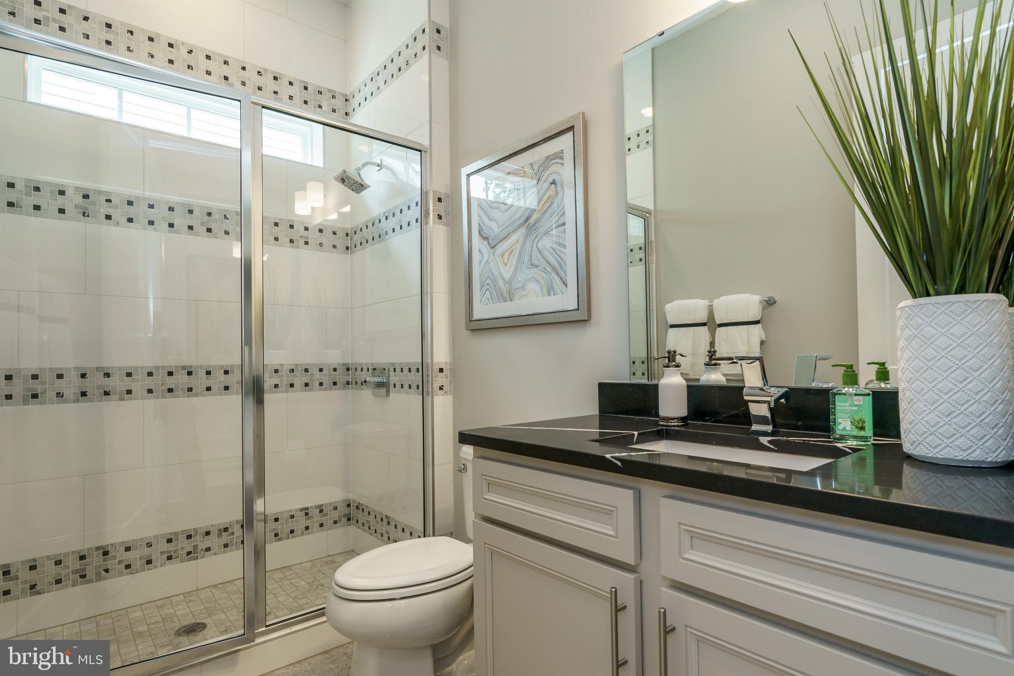 Tbb West Aster Way, Unit VIRTUOSO Gettysburg, PA 17325 - Photo 33 of 51 a bathroom with a granite countertop sink a toilet a mirror and shower