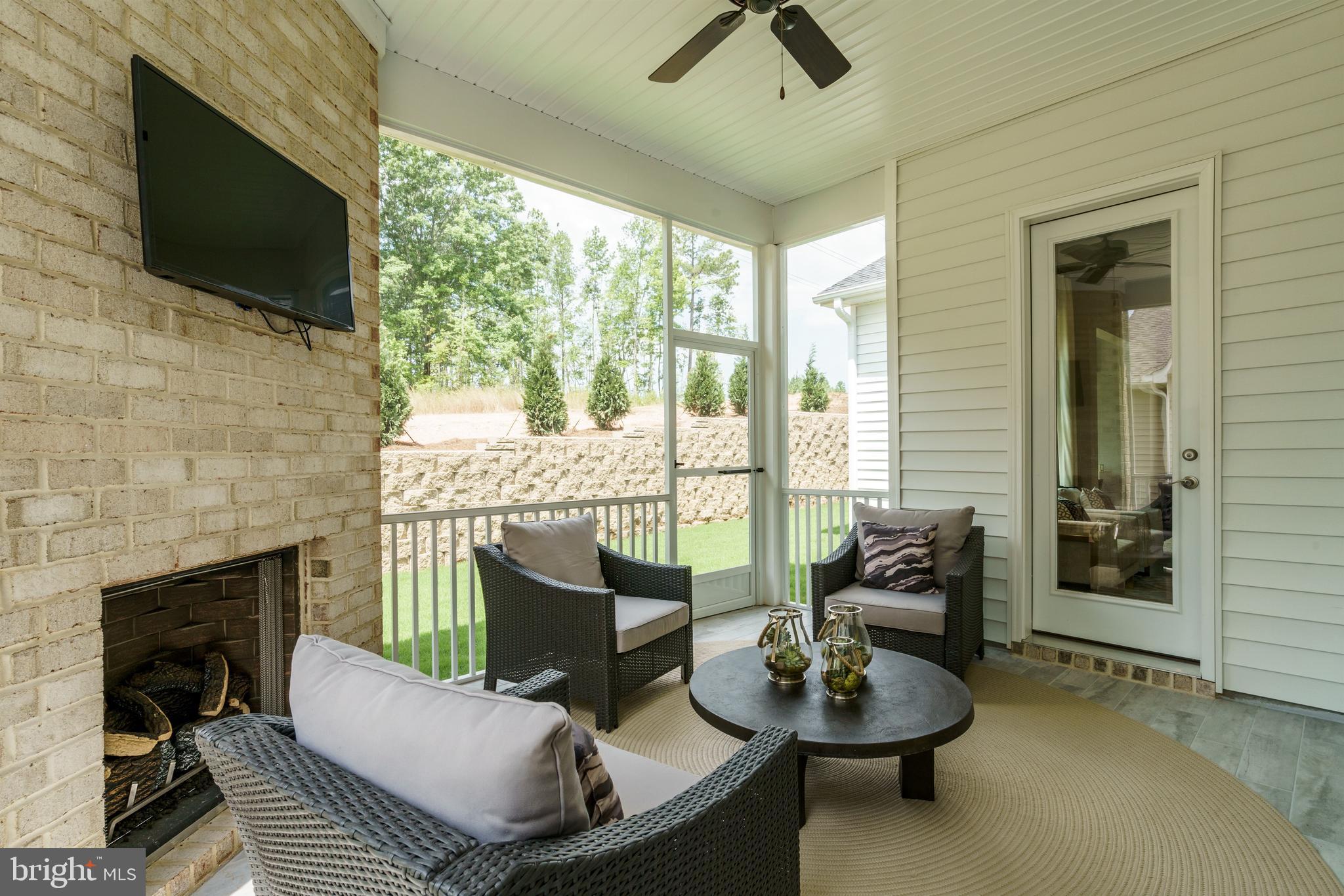 Tbb West Aster Way, Unit VIRTUOSO Gettysburg, PA 17325 - Photo 35 of 51 a living room with furniture a flat screen tv and a fireplace
