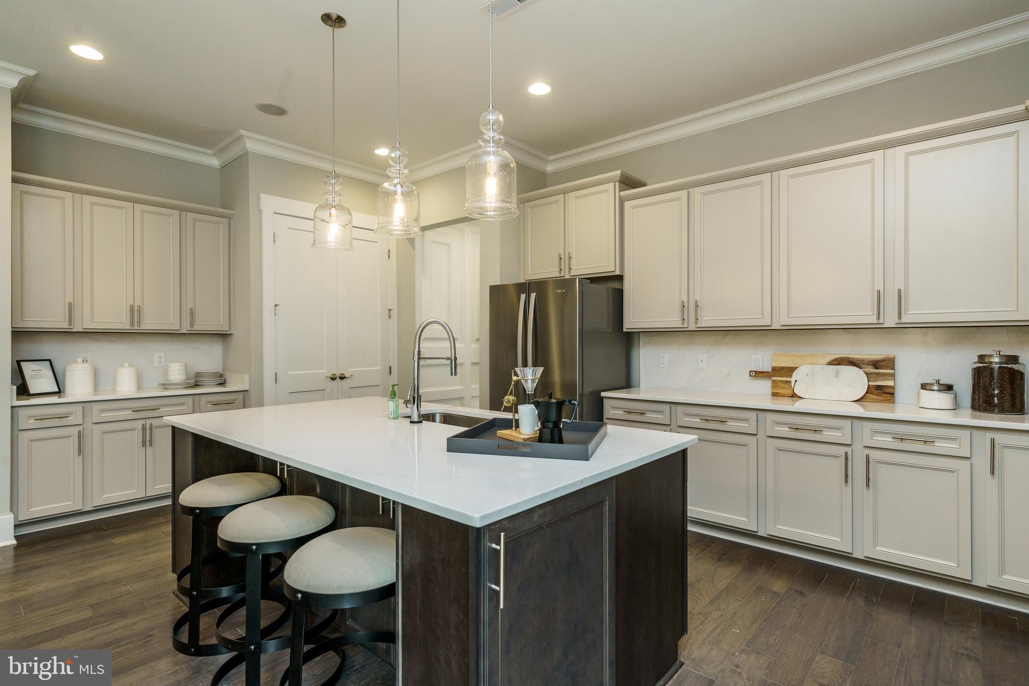 Tbb West Aster Way, Unit VIRTUOSO Gettysburg, PA 17325 - Photo 4 of 51 a kitchen with kitchen island granite countertop a sink cabinets and wooden floor