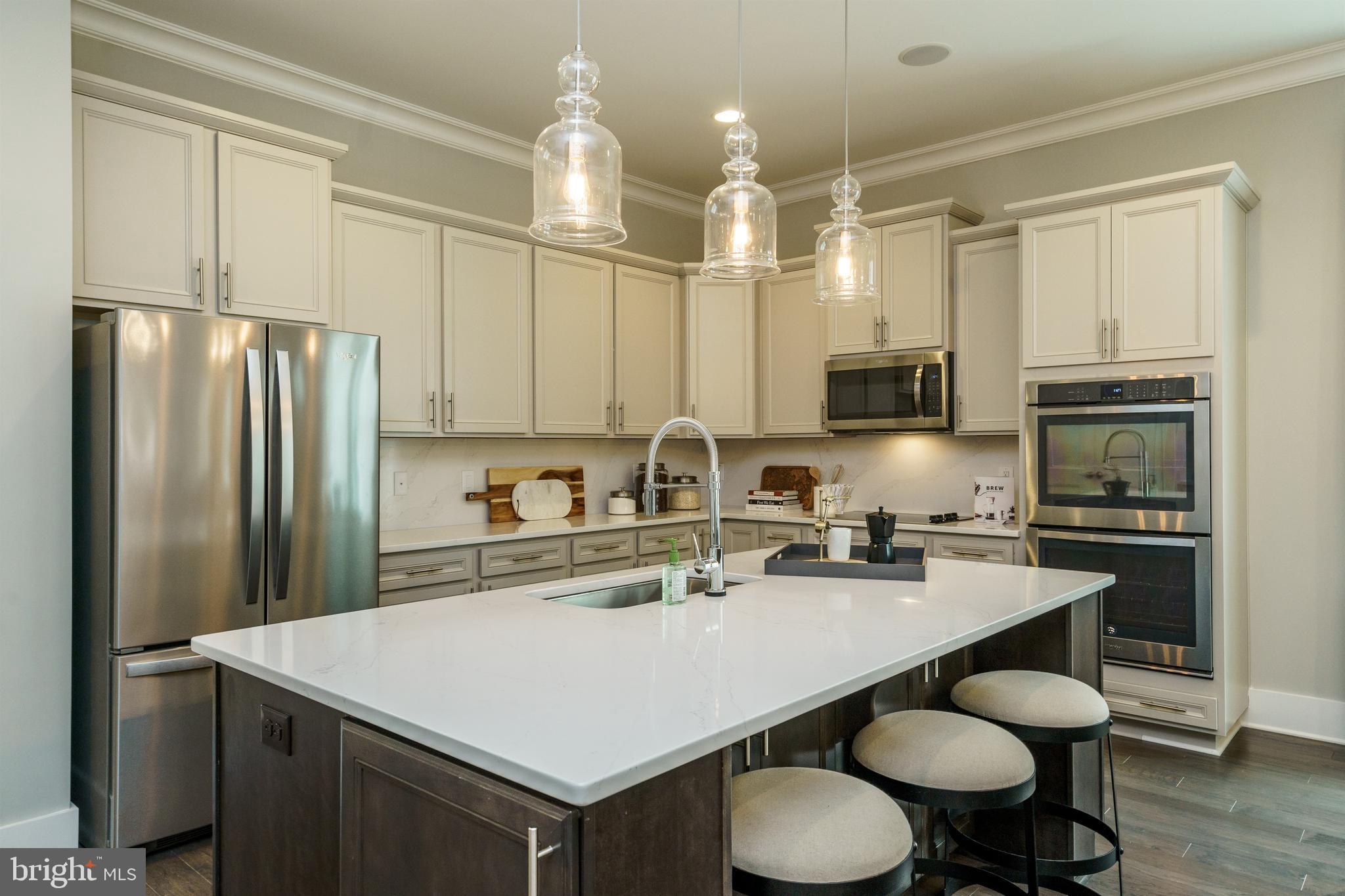 Tbb West Aster Way, Unit VIRTUOSO Gettysburg, PA 17325 - Photo 8 of 51 a kitchen with stainless steel appliances a sink a stove a refrigerator cabinets and chairs