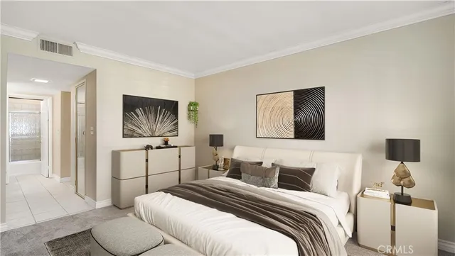 a bedroom with a bed and a lamp on dresser