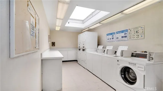 a view of washer and dryer with kitchen in the background