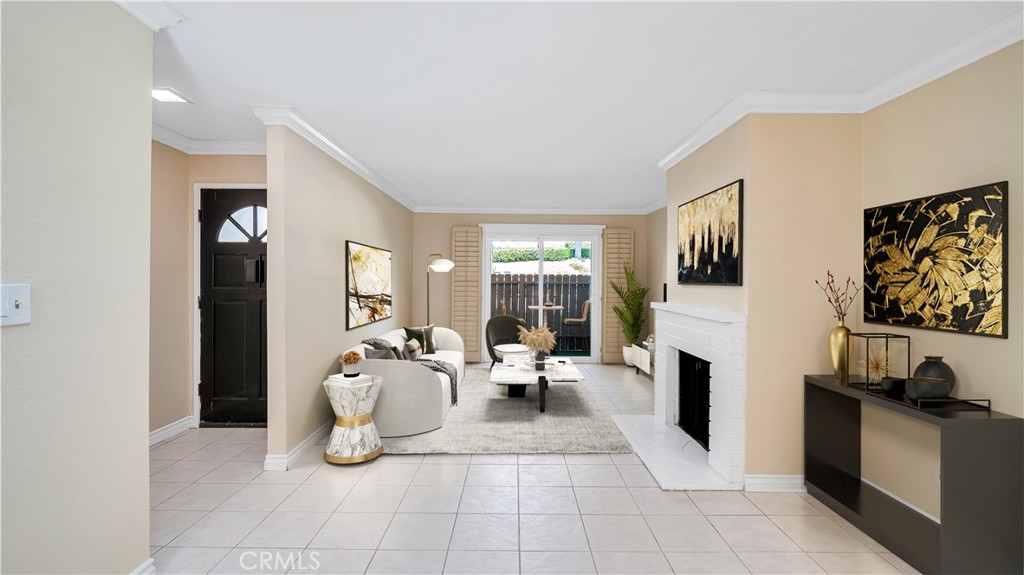 17522 Vandenberg Lane, Unit 3 Tustin, CA 92780 - Photo 2 of 27 a living room with furniture a fireplace and a flat screen tv