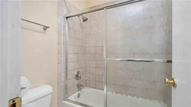 a bathroom with a shower and a toilet