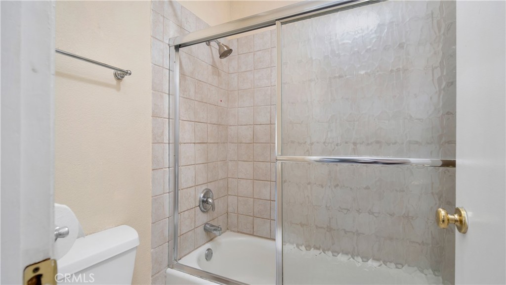 17522 Vandenberg Lane, Unit 3 Tustin, CA 92780 - Photo 24 of 27 a bathroom with a shower and a toilet