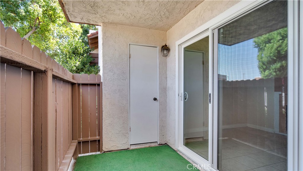 17522 Vandenberg Lane, Unit 3 Tustin, CA 92780 - Photo 27 of 27 a view of backyard with potted plants and wooden fence