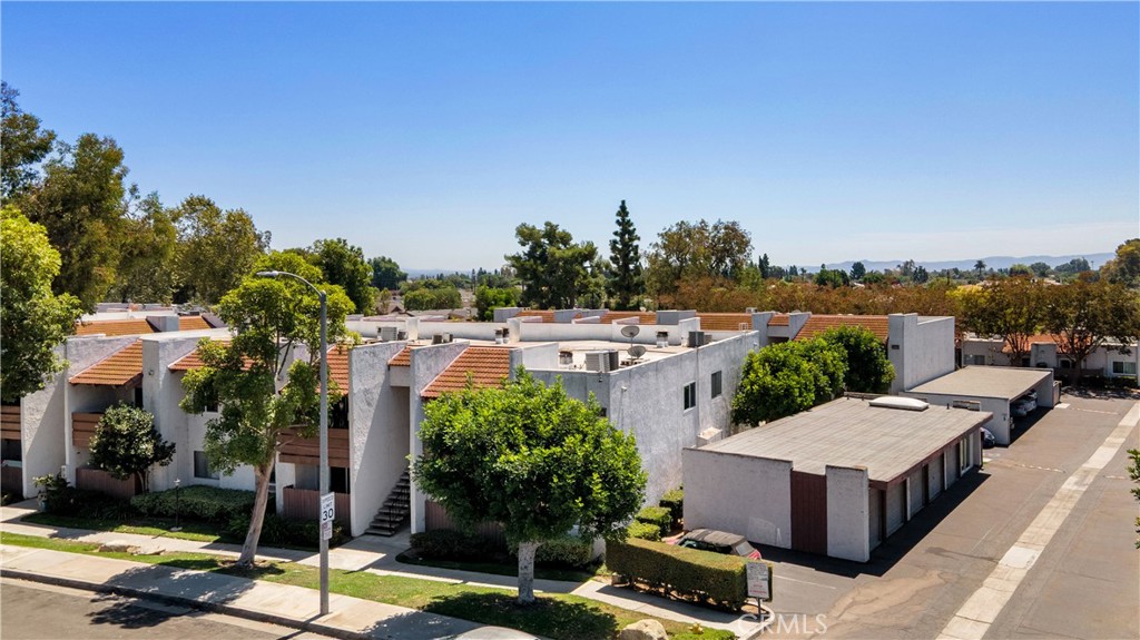17522 Vandenberg Lane, Unit 3 Tustin, CA 92780 - Photo 6 of 27 a view of a patio with table and chairs potted plants and a palm tree