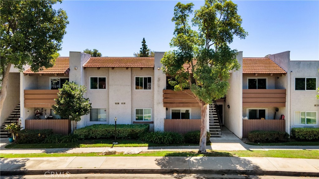 17522 Vandenberg Lane, Unit 3 Tustin, CA 92780 - Photo 7 of 27 a view of a white house with swimming pool next to a yard