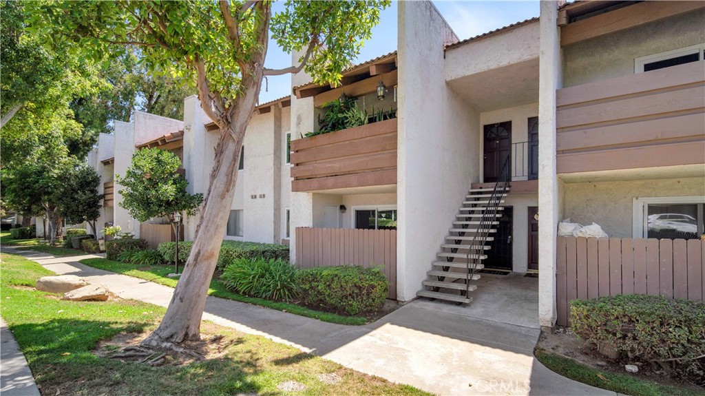 17522 Vandenberg Lane, Unit 3 Tustin, CA 92780 - Photo 8 of 27 a front view of a house with a yard